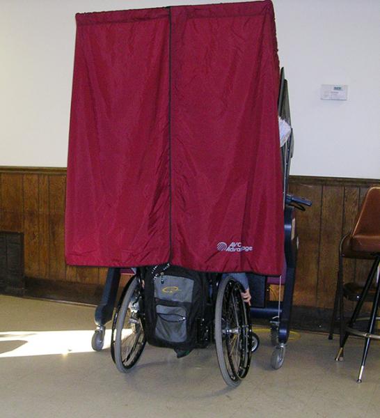photo of a person in a wheelchair voting