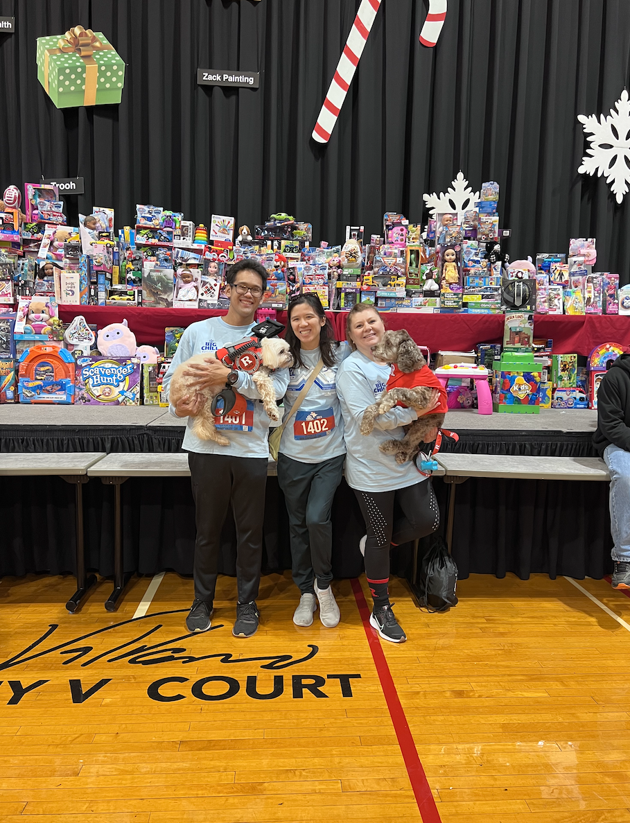 Image of SMLR Alumni at Big Chill 5k posing in front of toy donations