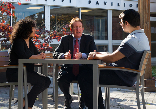 Image of students and faculty discussing negotiation techniques