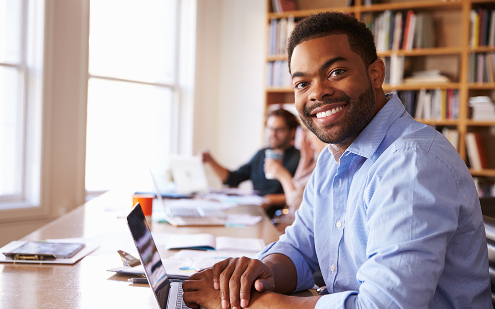 Image of man at desk in library