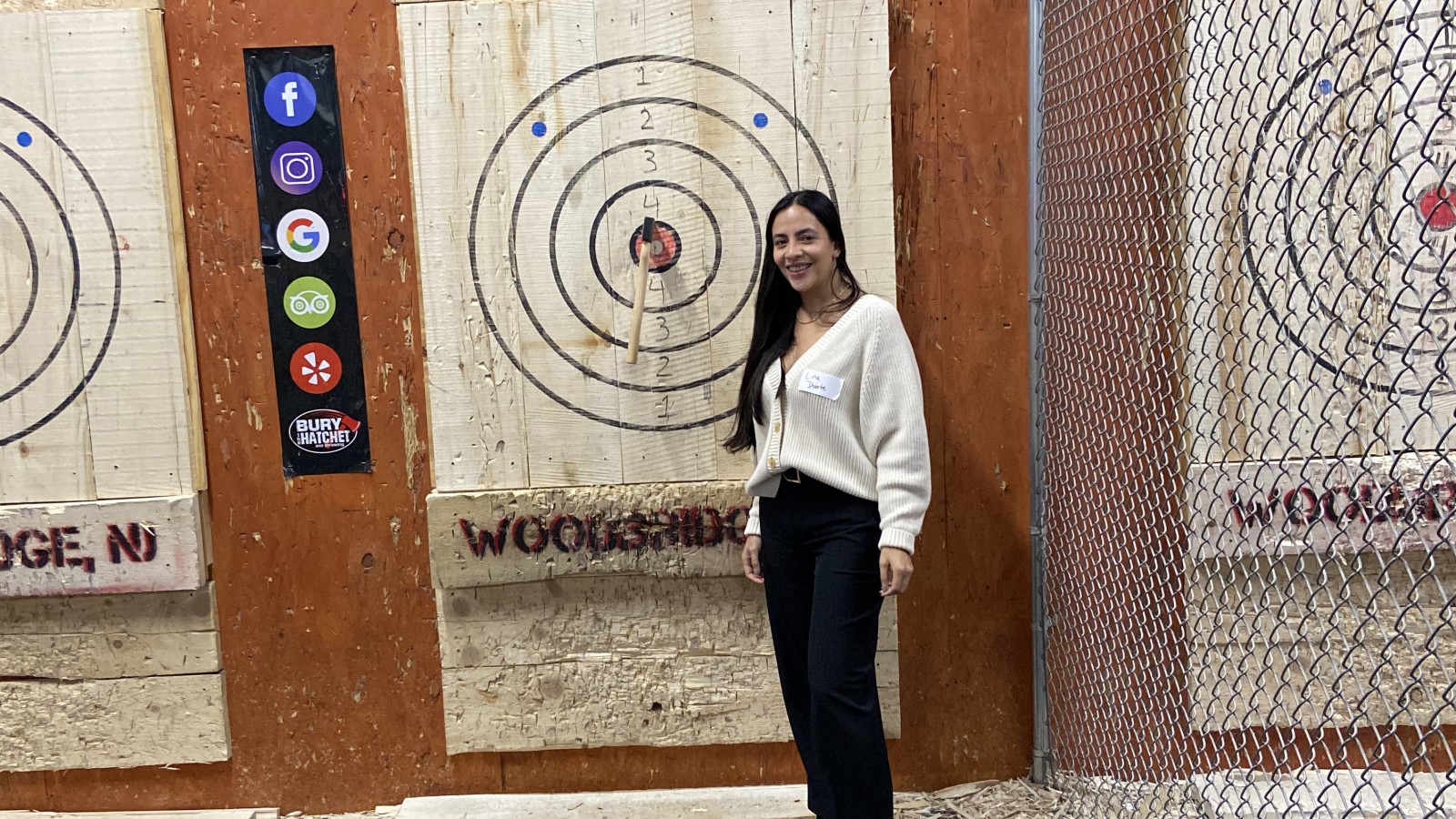 SMLR Alumna standing next to bulls-eye