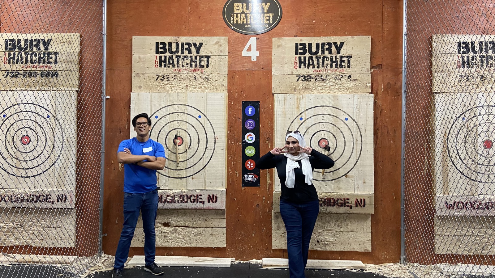 Two SMLR Alumni standing next to bulls-eyes