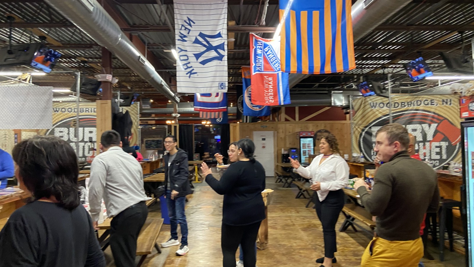 Group of SMLR Alumni gathered talking at Bury The Hatchet Axe Throwing