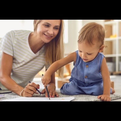 Image of woman drawing with a child