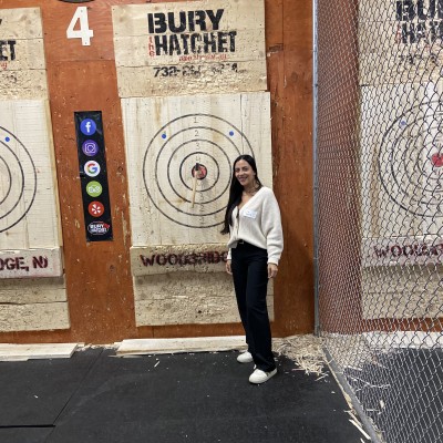 SMLR Alumna standing next to bulls-eye