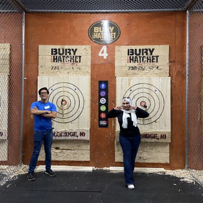 Two SMLR Alumni standing next to bulls-eyes