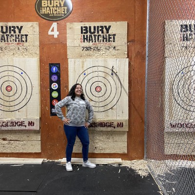 SMLR Alumna standing next to bulls-eye