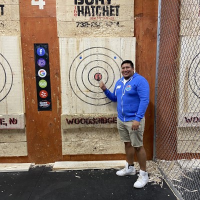 SMLR Alumna standing next to bulls-eye